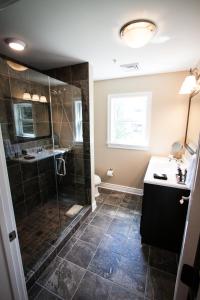 a bathroom with a shower and a sink at The Escape in Lewisburg