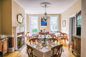 a dining room with tables and chairs and a fireplace at Hummingbird Inn in Easton