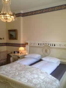 sypialnia z 2 łóżkami i żyrandolem w obiekcie Hotel Arkaden w mieście Arvika