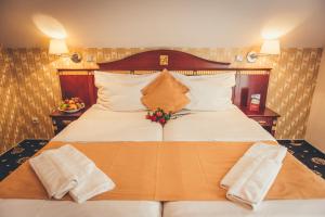 Hotel Tommy Wellness & Spa客房内的一张或多张床位