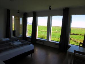 a hotel room with two beds and a window at Rauðaberg II in Raudaberg
