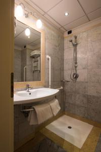 a bathroom with a tub, sink and mirror at Hotel Villa Cappugi in Pistoia