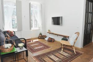 a living room with a couch and a tv at Abanotubani apartment in Tbilisi City