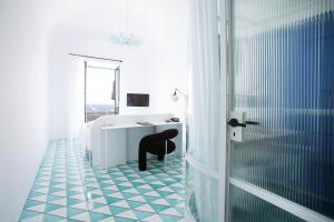a room with a white marble floor and a black and white checkered at Miramare Sea Resort & Spa in Ischia