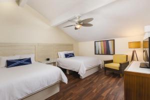 a bedroom with two beds and a ceiling fan at Margaritaville Vacation Club by Wyndham - St Thomas in Frydendal