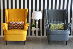 two chairs sitting next to each other next to a lamp at Vinha da Areia Beach Hotel in Vila Franca do Campo