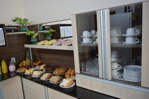 a display cabinet filled with different types of food at Hotel Consalter in Rodeio Bonito