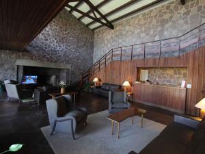 a living room with couches chairs and a fireplace at Hotel Terraza del Mar in Punta del Este