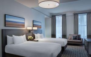 a hotel room with two beds and a couch at Hyatt Regency Cleveland at The Arcade in Cleveland +20 photos