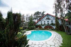 a house with a swimming pool in the yard at Cabaña Suiza in Guatemala