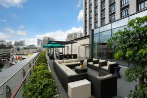 a rooftop patio with seating on a building at Hyatt Place Shenzhen Dongmen in Shenzhen
