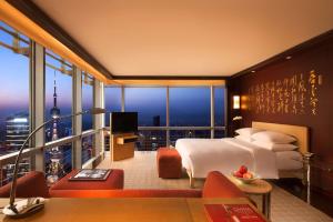 a hotel room with a bed and a large window at Grand Hyatt Shanghai in Shanghai