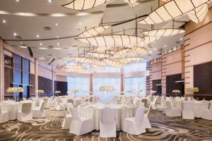 a banquet hall with white tables and white chairs at Hyatt on the Bund in Shanghai