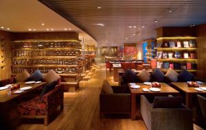 a restaurant with couches and tables in a room at Hyatt on the Bund in Shanghai