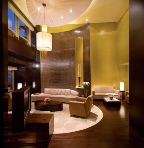 a living room filled with furniture and a large mirror at Hyatt on the Bund in Shanghai