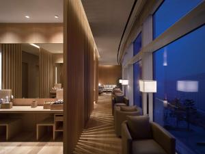 a living room with a couch and a dining room table at Park Hyatt Busan in Busan