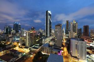 a city skyline at night with a lot of buildings at Hotel Dann Carlton Marinn Place Panama Financial District in Panama City