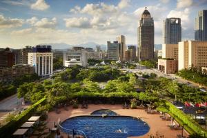 a view of a city skyline with a swimming pool at Grand Hyatt Taipei in Taipei