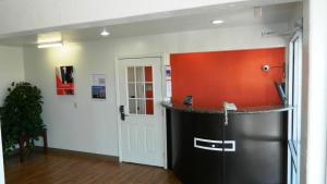 a room with a counter with an orange wall at Motel 6-Oklahoma City, OK - Airport East in Oklahoma City