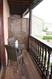 a patio with a table and chairs on a balcony at Trisileja en Posada La Busta in La Busta