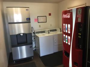 a kitchen with a cocacola refrigerator and a counter at Days Inn by Wyndham Los Angeles LAX/ Redondo&ManhattanBeach in Lawndale