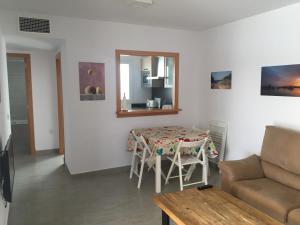 a living room with a table and a couch at Ses Sivines 25 in Ciutadella