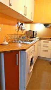 a kitchen with a washing machine and a sink at EZY Ramos apartment Alfama in Lisbon