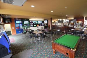 a room with a pool table and tables and chairs at Rubicon Hotel Motel in Eildon