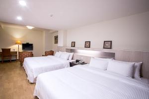Ένα ή περισσότερα κρεβάτια σε δωμάτιο στο Huang Shin Business Hotel-Shang An