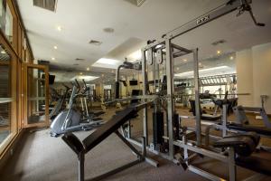 a gym with treadmills and elliptical machines at Hotel Santika Cirebon in Cirebon