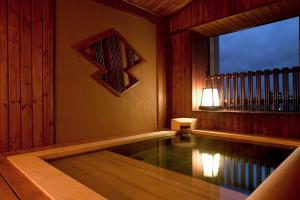 a swimming pool in a room with a window at Hotel Rio (Adult Only) in Sapporo