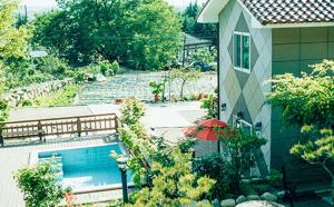 a house with a swimming pool next to a house at Utopia Pension in Gyeongju