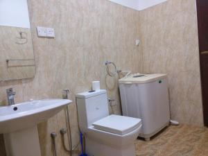 a bathroom with a white toilet and a sink at Villa Happy Home in Bentota +38 photos