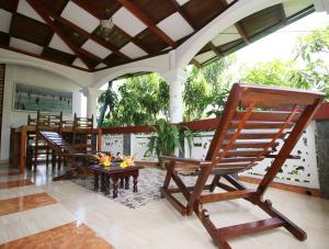 two rocking chairs on a porch with a table at Anjana Villa in Galle