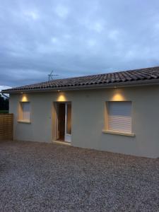 a house with two windows and a roof at Au charmant des vignes in Montagne +7 photos