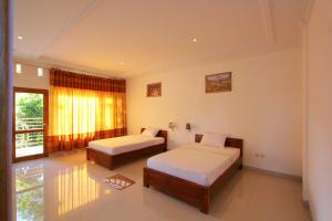 מיטה או מיטות בחדר ב-Bali Bening
