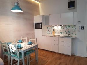 kuchnia ze stołem i krzesłami w kuchni w obiekcie Houseboat Apartment w mieście Sopot
