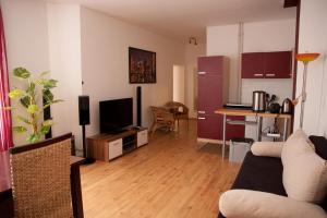 a living room with a couch and a kitchen at Apartments City Room Berlin in Berlin