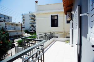 a balcony with a railing next to a building at Loft near the beach in Loutraki