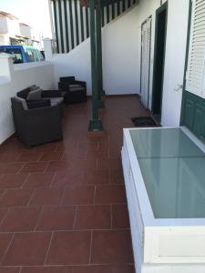 a patio with couches and a glass table at Casa Bonita in Abades