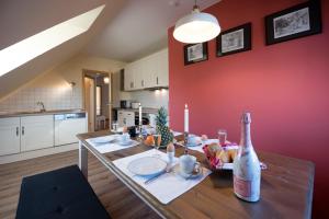 a kitchen with a table with a bottle of champagne at Bellevue Ferienwohnungen in Quedlinburg