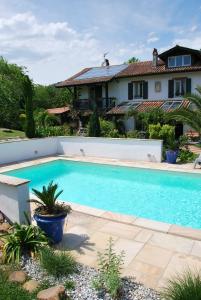 a swimming pool in front of a house at Maison Aretxola in Sare