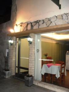 Habitación con mesa y puerta de cristal con mesa en Las Heras Hotel en Mar del Plata