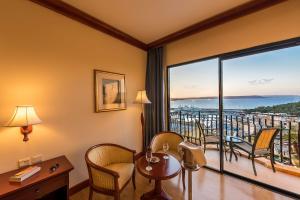 a hotel room with a view of the ocean at Grand Hotel Gozo in Għajnsielem