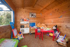 a room with a kitchen and a table in a cabin at Holiday Park Mandrice in Mandre