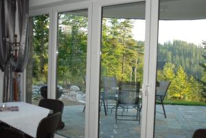 a screened in porch with a view of a table and chairs at Villa Park in Bukowina Tatrzańska