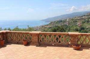 a brick balcony with a view of the ocean at Casetta ai Malvitani in Cetraro