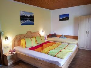 a bedroom with two beds with colorful blankets at Haus Margret in Stummerberg