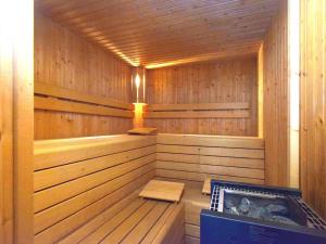 a large wooden sauna with a tub in it at Holiday home with pool near park and ski area in Xhoffraix