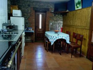 a kitchen with a table and a kitchen with a refrigerator at Callejon de la Vega in Ríocaliente +24 photos